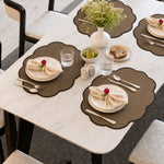 Brown | Brown Scalloped Round Woven Polyester Placemats styled on a dining table