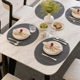 Charcoal | Charcoal Round Woven PVC-Polyester Placemats styled on a dining table