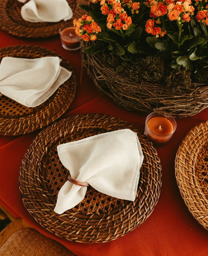 Linen napkins with wooden napkin rings in a warm floral table setting